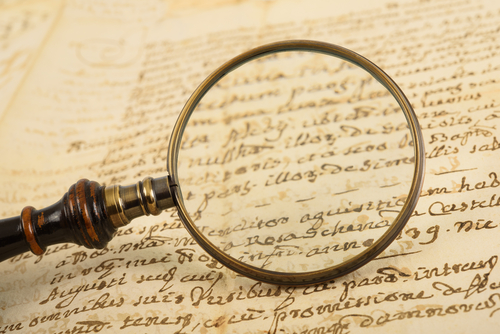 a manuscript with a magnifying glass